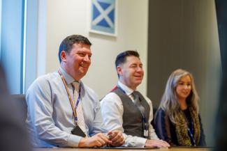 Staff in the boardroom in Low Moss