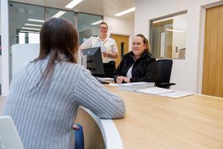 Staff and prisoner at desk in Stirling