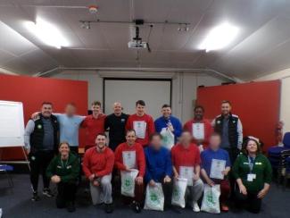 Group photo of participants with certificates