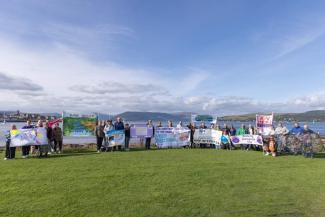groups of people standing with banners