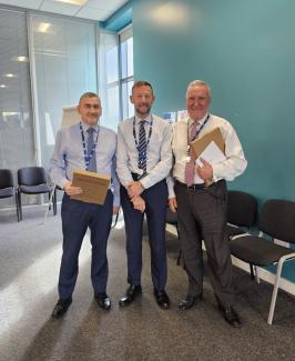 Three men standing together