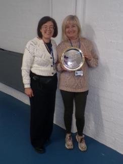 One woman presenting an award to another