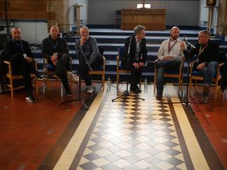 Six individuals sitting on a panel